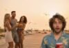 Jersey Shore 2025: Where Are They Now and Who’s Still Fighting? "A blurry, wide-eyed person holding a red cup, photobombing a group reunion on a beach boardwalk."