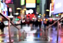 The Celebs Who Skipped the Met Gala — And Why Fans Are Furious A low-angle, rain-slicked view of empty stone steps leading up to blurred Times Square billboards and lights at night, evoking a quiet, abandoned vigil.