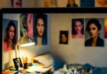 Celebrity Rebound Relationships That Got Real, Fast A dimly lit, cluttered NYC bedroom at 2 a.m., glimpsed voyeuristically through a smudged laptop screen: rumpled blue sheets, scattered papers, and blurred celebrity posters suggesting tangled romantic rebounds.